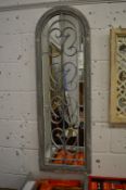 A pair of decorative arch shaped mirrors with grey painted frames.