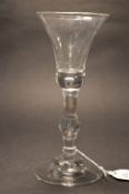 A good George III wine glass with baluster stem and bell shaped bowl.