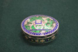 A small oval enamel silver box and cover.