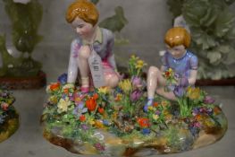 A Crown Staffordshire porcelain group modelled by Bayley depicting children picking flowers together