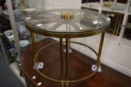 A brass and glass wagon wheel style coffee table.