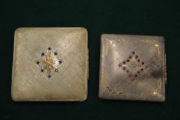 Two silver and gem set compacts.