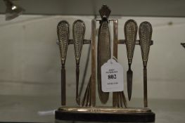 An Art Deco silver part manicure set with original stand.