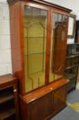A good quality mahogany display cabinet with cupboard doors below.