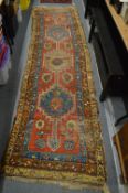 An old Persian runner, worn, 290cm x 84cm.