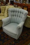 A pale blue upholstered armchair.