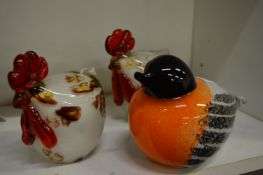 A moulded glass paperweight modelled as a robin together with two glass chickens.