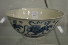 A Chinese blue and white circular bowl decorated with lion dogs.