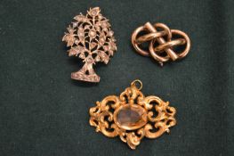 Three decorative brooches.
