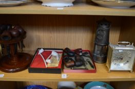 Various smokers pipes, a carriage clock and a miners lamp.
