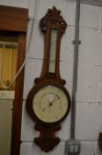 A Victorian oak cased barometer/thermometer.