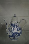 A Chinese blue and white ewer decorated with a dragon.