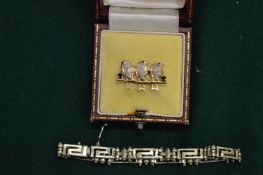 A gold and gem set brooch modelled as three birds on a branch together with a bracelet.