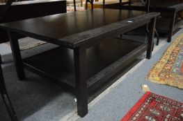 A pair of ebonised two tier coffee tables.