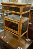A bamboo and lacquer panelled sewing/work table.