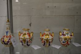 A garniture of four small pieces of Crown Derby to include a scent bottle and stopper and three