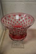 A large ruby tinted cut glass pedestal vase (small chip to the corner of the foot rim).