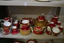 A large quantity of Spode dinner, tea and coffee ware, burgundy ground with a gilded crest.
