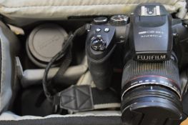 A Fuji film HS 20EXR camera and accessories. cased.