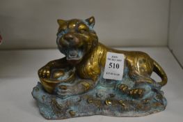 A small brass figure of a tiger.