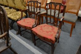 A pair of Hepplewhite style mahogany elbow chairs and a similar side chair.