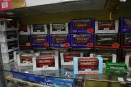 A quantity of boxed die-cast model buses.
