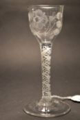A good George III wine or cordial glass with air twist stem, the bowl engraved with flowers and a