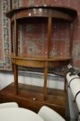 A mahogany drop-leaf dining table with a pair of matching D ends.