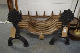 A pair of cast iron wheat sheaf fire dogs with fire basket.