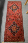 A small Persian design rug, 148cm x 55cm.