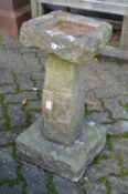A stone effect bird bath.
