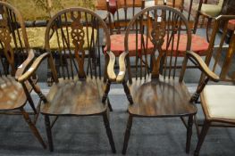 A pair of wheel back armchairs.