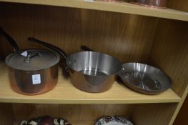 Two copper saucepans and a similar frying pan.