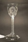 A George III wine or cordial glass with opaque air twist stem, the bowl engraved with flowers.