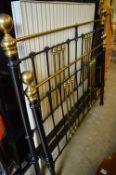 A Victorian style brass and painted cast iron double bed frame.