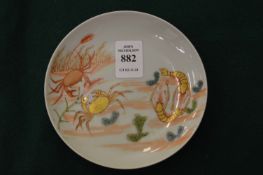 A small Japanese circular dish, gilt decorated with crustaceans.
