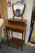 A mahogany washstand or dressing table with shield shaped mirror over an arrangement of small