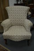 An upholstered bedroom chair on cabriole legs.