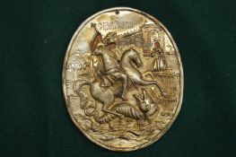 An embossed silver plaque, St. George slaying the dragon.