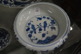 A Chinese blue and white circular bowl painted with birds on a branch.