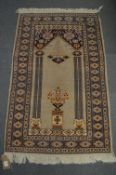 A Persian prayer rug, 119cm x 74cm.