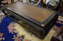 A large Chinese day bed with distressed frame.
