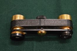 A pair of miniature opera glasses.