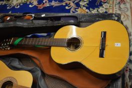 An Aria classical guitar numbered A551 with outer case.