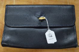 A Longchamp black leather clutch bag.