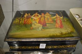 A Russian lacquer box containing a small quantity of jewellery.
