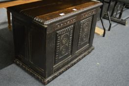 A carved oak storage box.