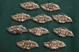 Ten cast metal menu holders.