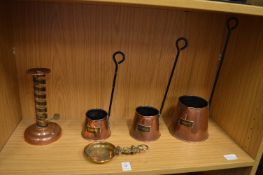 A set of three copper cider measures and other items.
