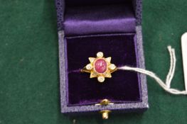 An 18ct gold diamond and cabochon ruby ring.